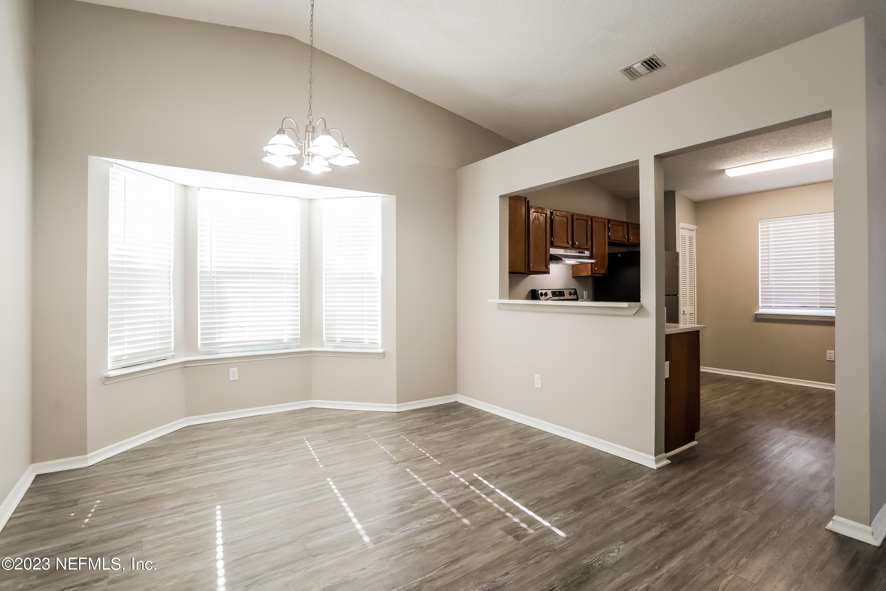 7684 Collins Ridge Boulevard Jacksonville, FL 32244 - Photo 5 of 15 an empty room with wooden floor and windows