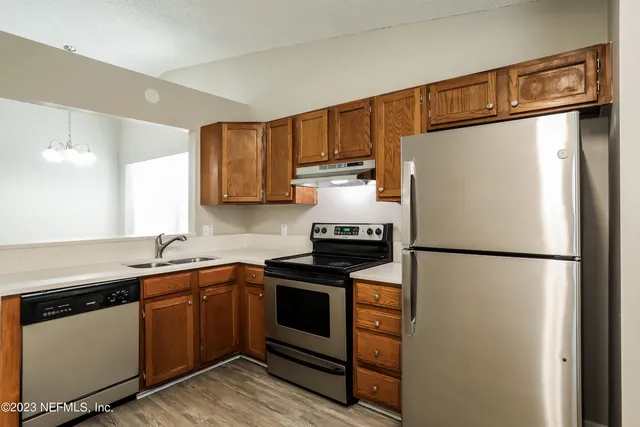 a kitchen with a refrigerator sink and stove
