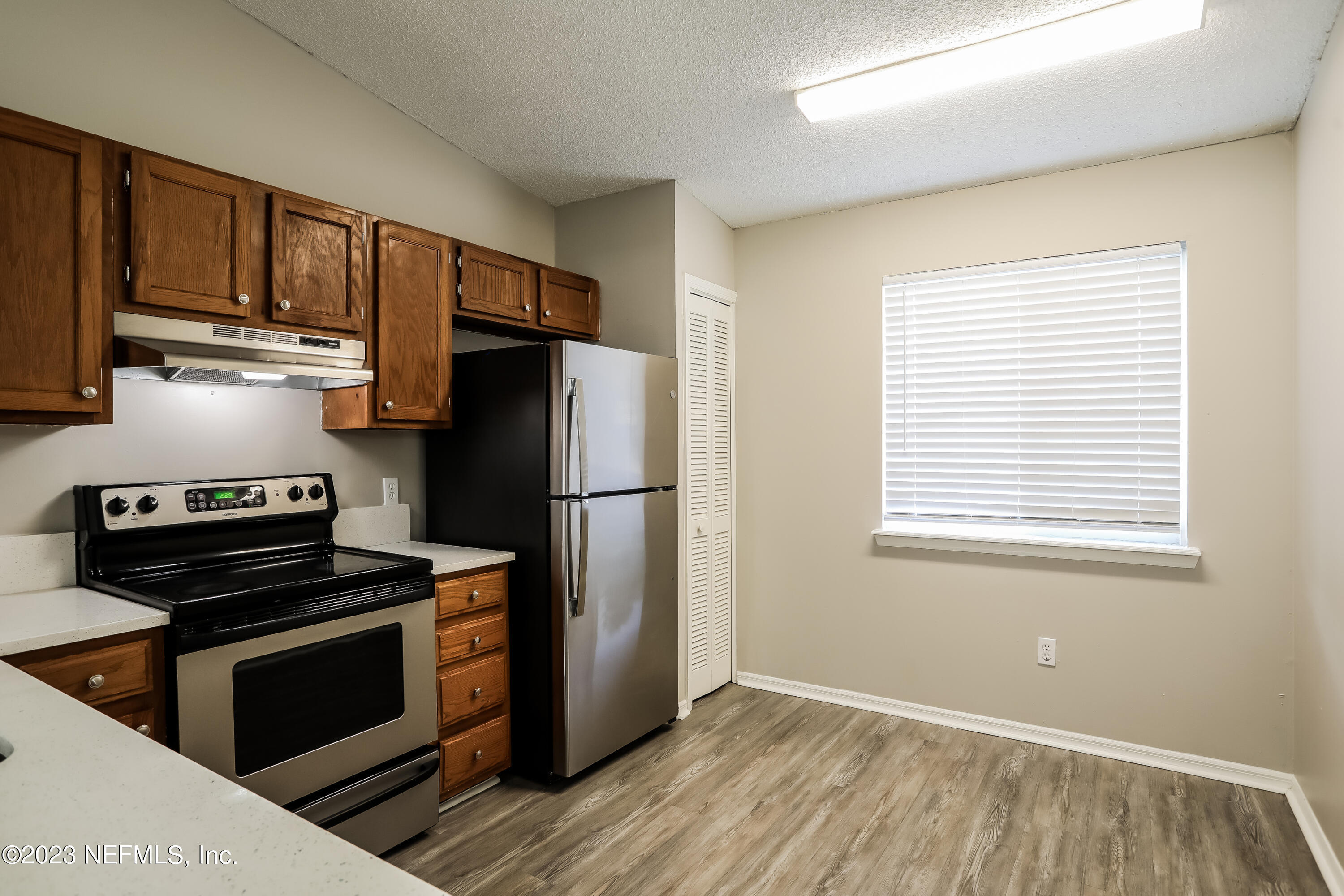 7684 Collins Ridge Boulevard Jacksonville, FL 32244 - Photo 7 of 15 a kitchen with a refrigerator stove and cabinets