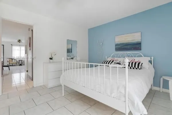 a view of a bedroom with furniture and windows