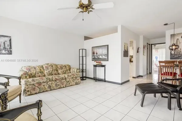 a living room with furniture and a dining table