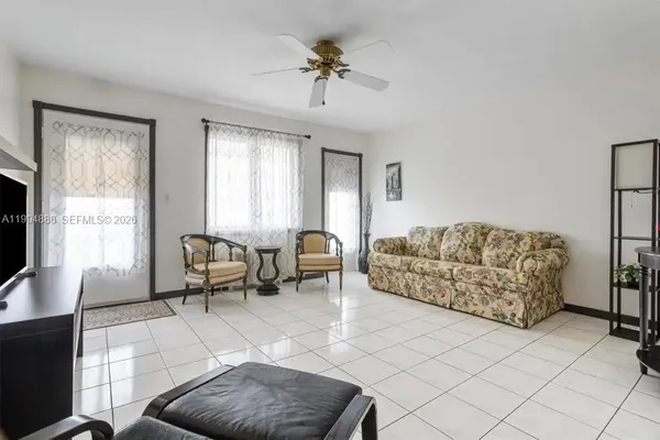 a living room with furniture and a flat screen tv