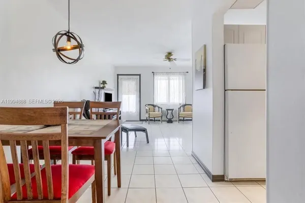 a very nice looking room with a dining table chairs and entryway