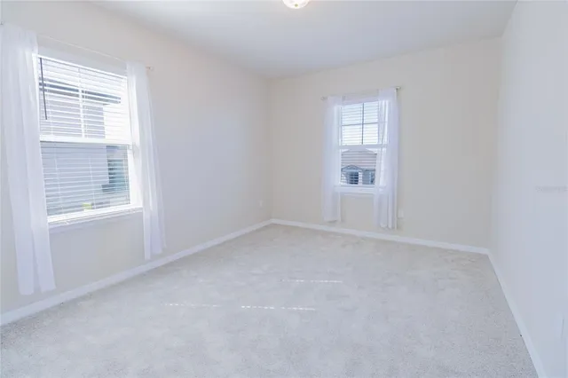 a view of empty room with windows