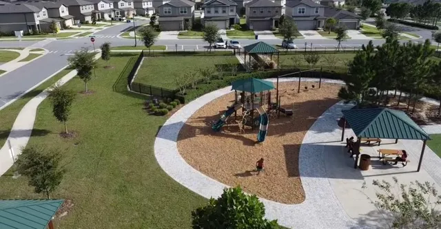 an aerial view of a house with a yard basket ball court and outdoor seating