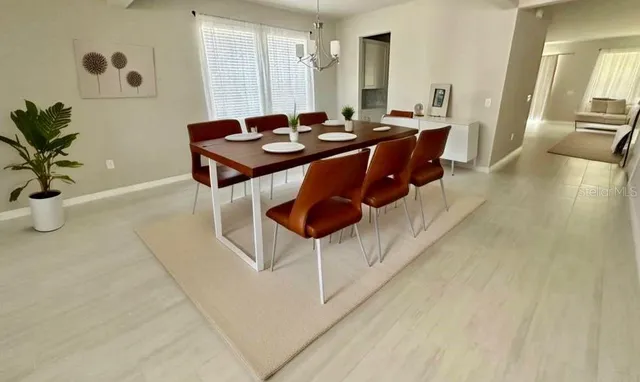 a dining room with furniture and wooden floor