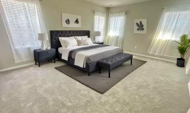 a spacious bedroom with a bed and a couch