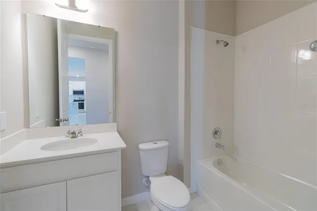 a bathroom with a sink a toilet and bathtub