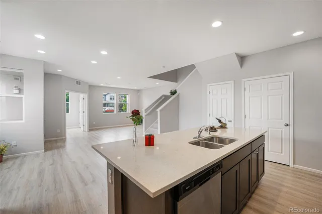 a kitchen with sink cabinets and wooden floor