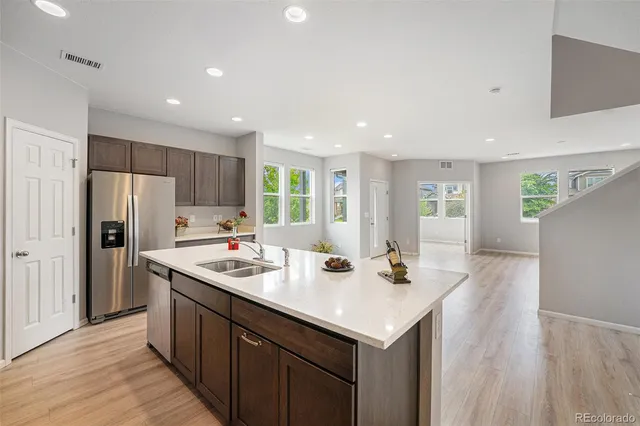 a kitchen with stainless steel appliances a sink stove and refrigerator