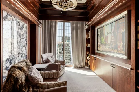 a living room with furniture large window and a table