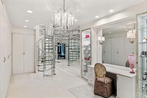 a view of a room with furniture and chandelier