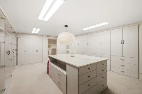 a view of a dining room with furniture and floor to ceiling window