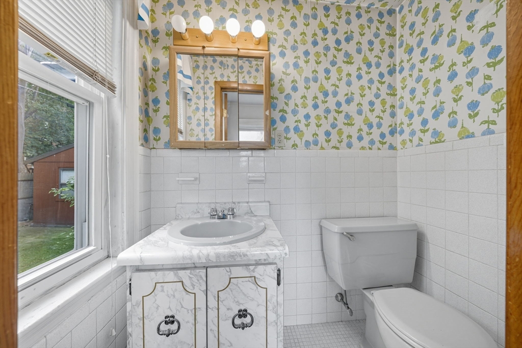 28 Verndale Street Brookline, MA 02446 - Photo 11 of 42 a bathroom with a toilet sink and mirror