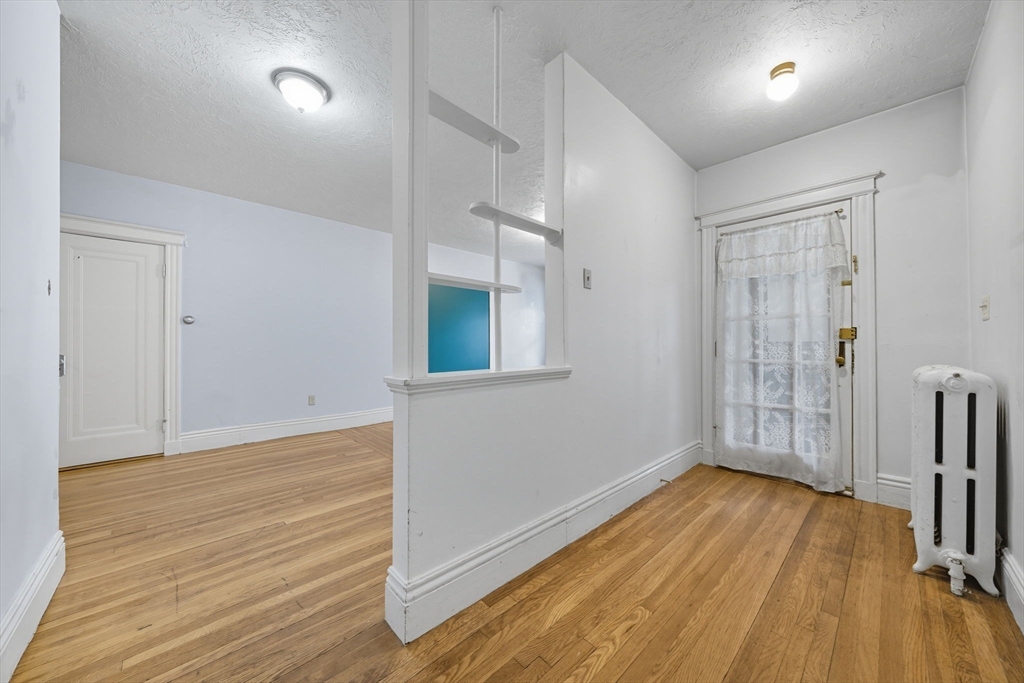 28 Verndale Street Brookline, MA 02446 - Photo 13 of 42 wooden floor in an empty room with a window