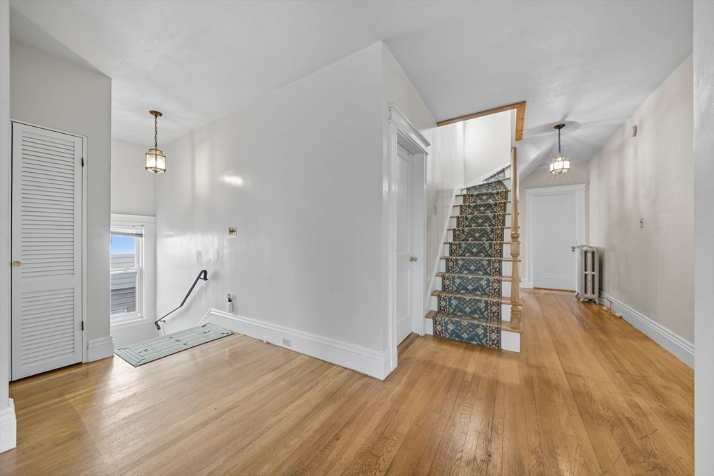 28 Verndale Street Brookline, MA 02446 - Photo 14 of 42 wooden floor in an empty room with a window