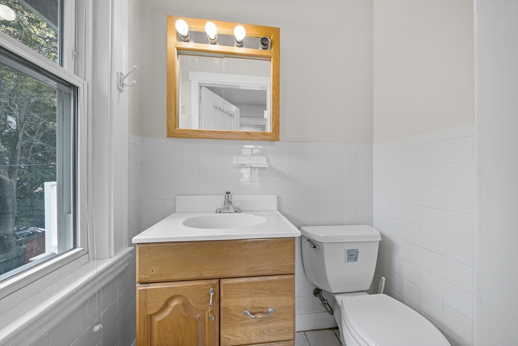 28 Verndale Street Brookline, MA 02446 - Photo 25 of 42 a bathroom with a toilet sink vanity and mirror