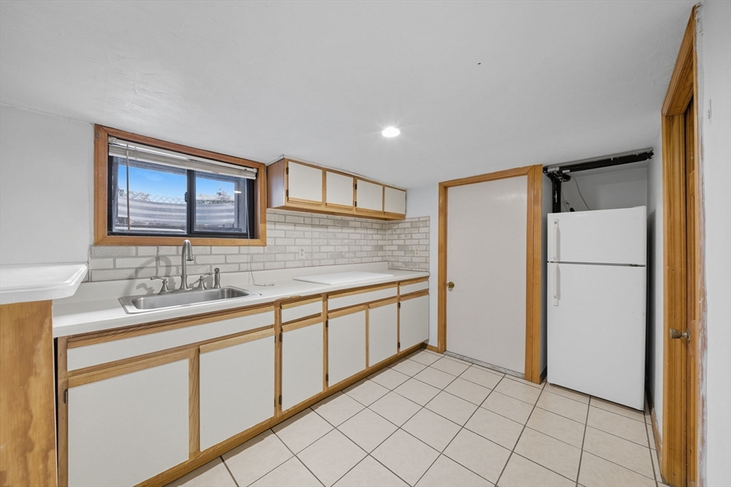 28 Verndale Street Brookline, MA 02446 - Photo 35 of 42 a bathroom with a sink a mirror and a shower