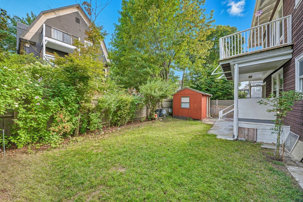 28 Verndale Street Brookline, MA 02446 - Photo 40 of 42 a backyard of a house with table and chairs a barbeque