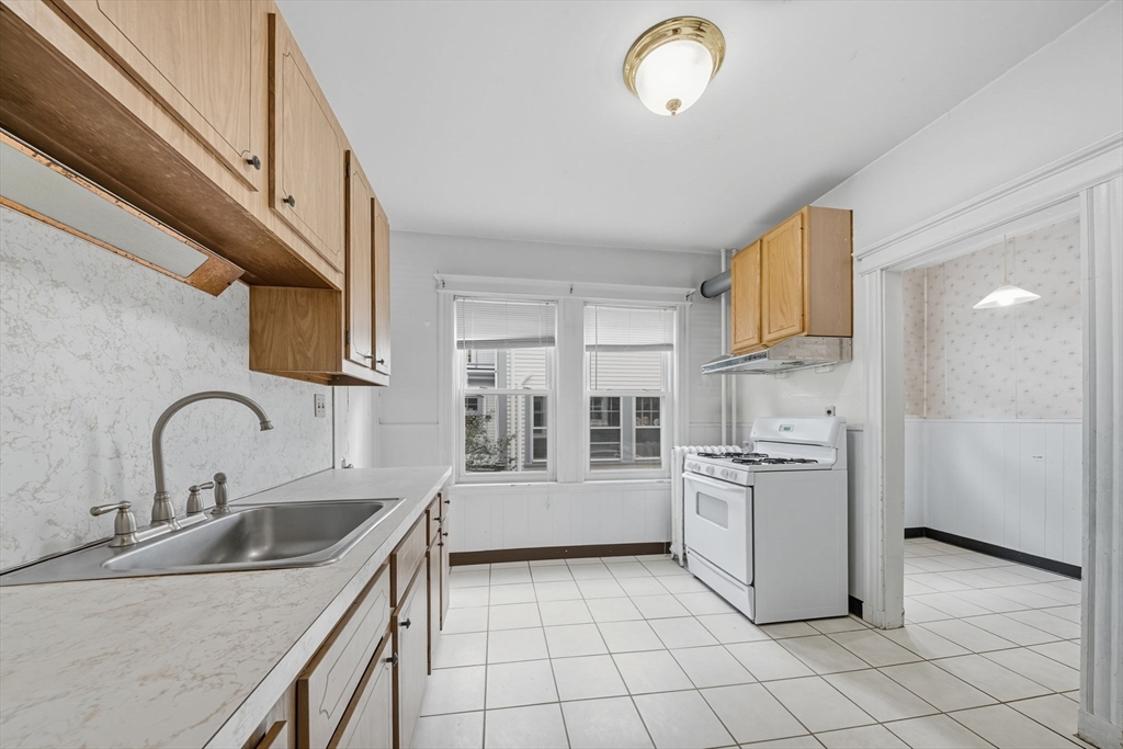 28 Verndale Street Brookline, MA 02446 - Photo 4 of 42 a kitchen with a sink appliances and cabinets