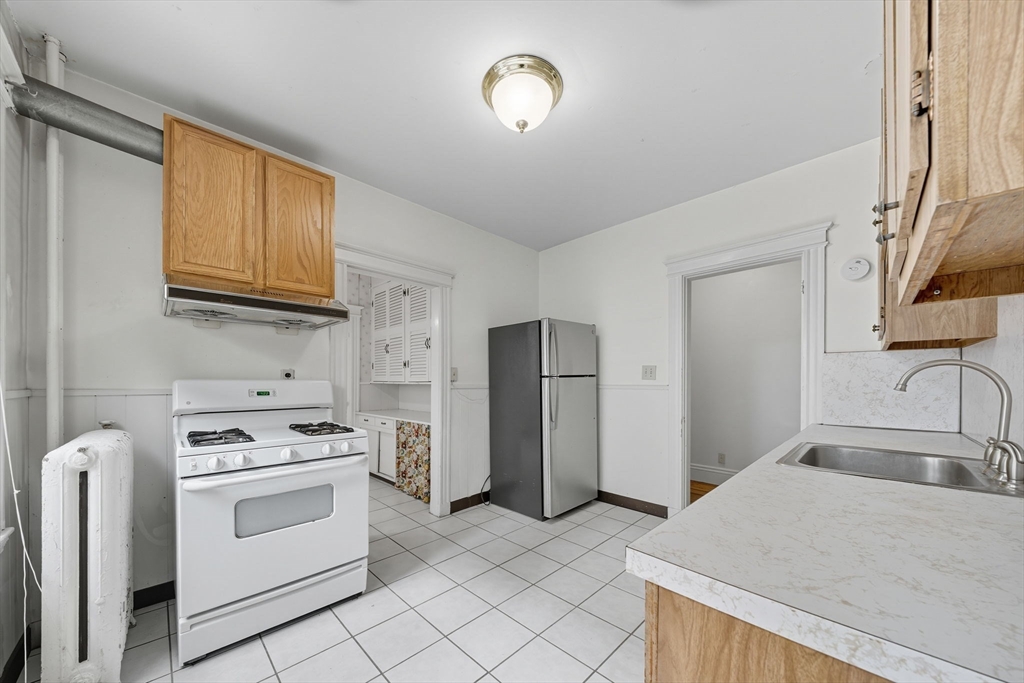 28 Verndale Street Brookline, MA 02446 - Photo 5 of 42 a kitchen with appliances cabinets and a sink