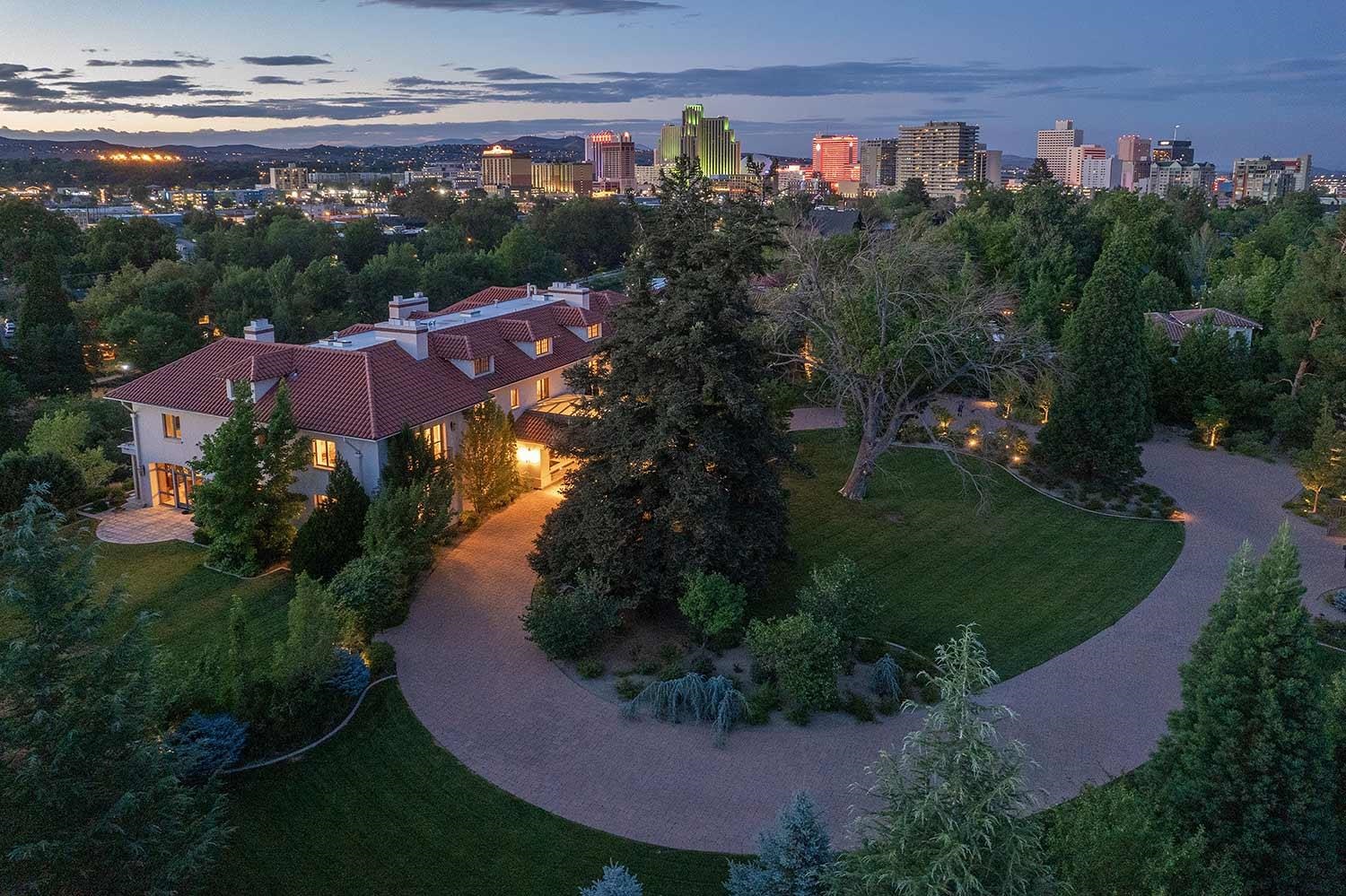 an aerial view of a house with garden space lake and mountain view in back