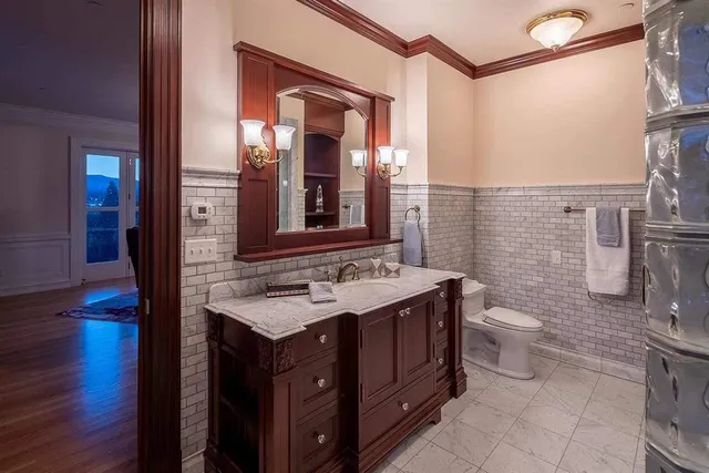 a bathroom with a sink a toilet and shower a mirror