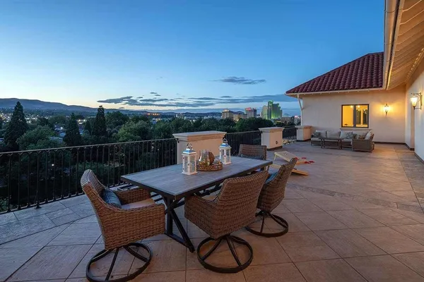 a terrace with outdoor seating and city view