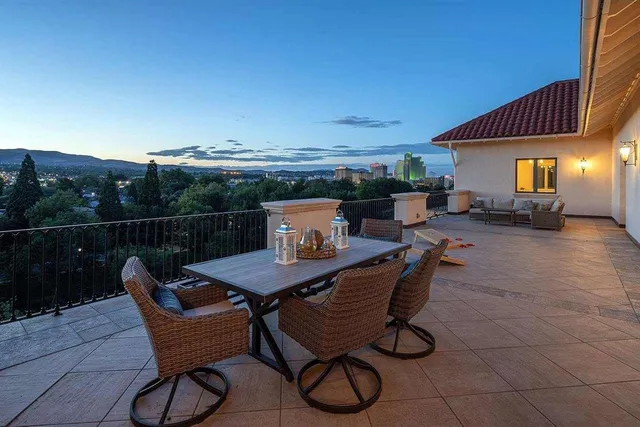 a terrace with outdoor seating and city view