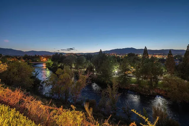 a view of a lake in middle of the forest