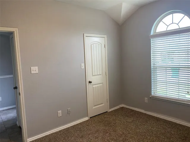 an empty room with windows and closet