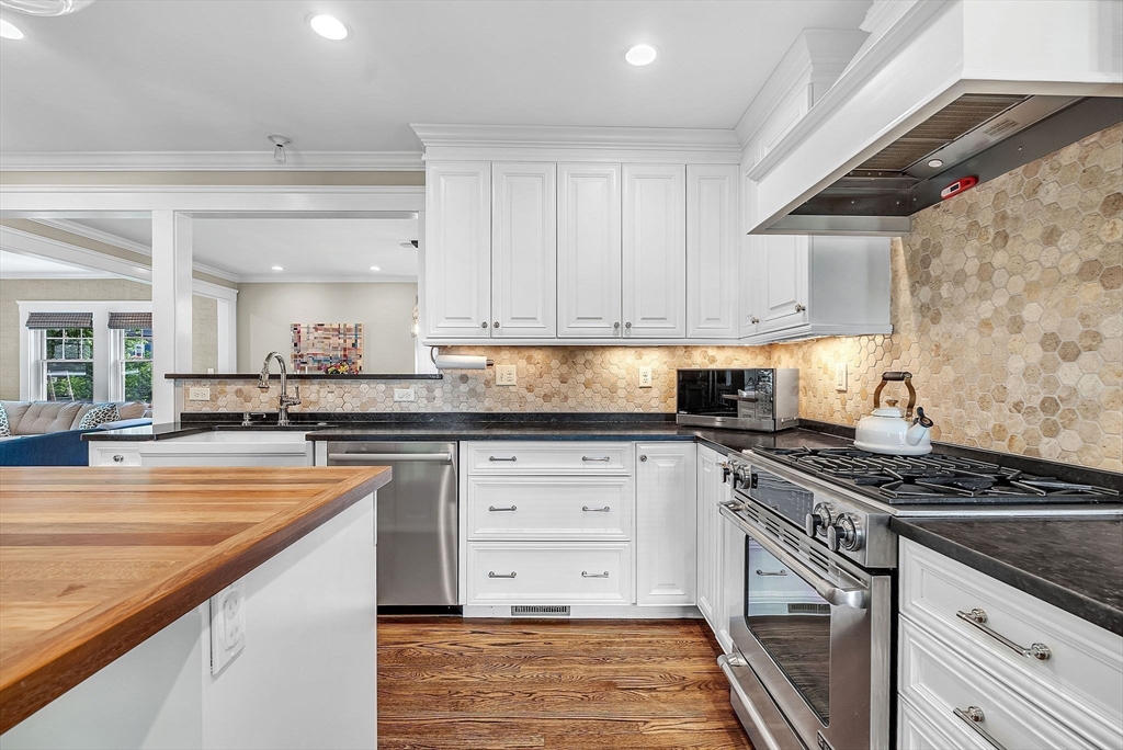 3 Thorpe Road Needham, MA 02494 - Photo 13 of 36 a kitchen with granite countertop a stove sink and cabinets