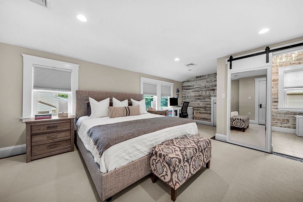 3 Thorpe Road Needham, MA 02494 - Photo 21 of 36 a bedroom with a large bed and a chandelier