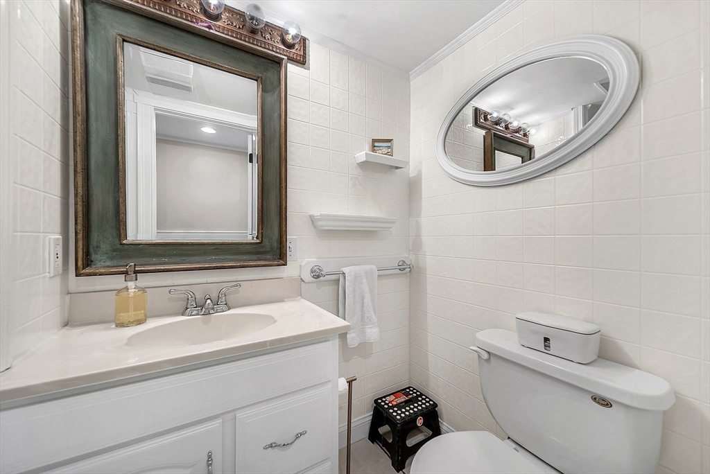 3 Thorpe Road Needham, MA 02494 - Photo 30 of 36 a bathroom with a toilet a sink and a mirror