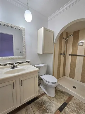 a bathroom with a sink toilet and shower