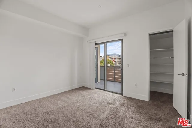 a view of an empty room with a closet