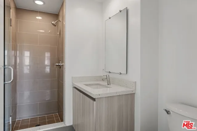 a bathroom with a shower and a sink