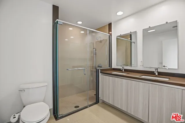 a bathroom with a granite countertop sink mirror and toilet