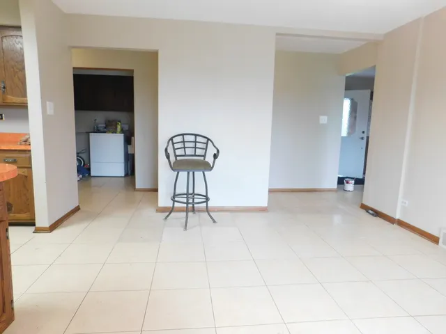 a view of empty room with wooden floor and cabinet