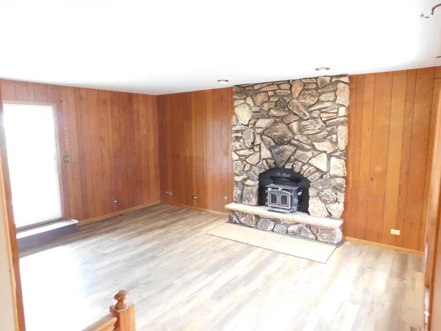 a view of a room with furniture and a fireplace