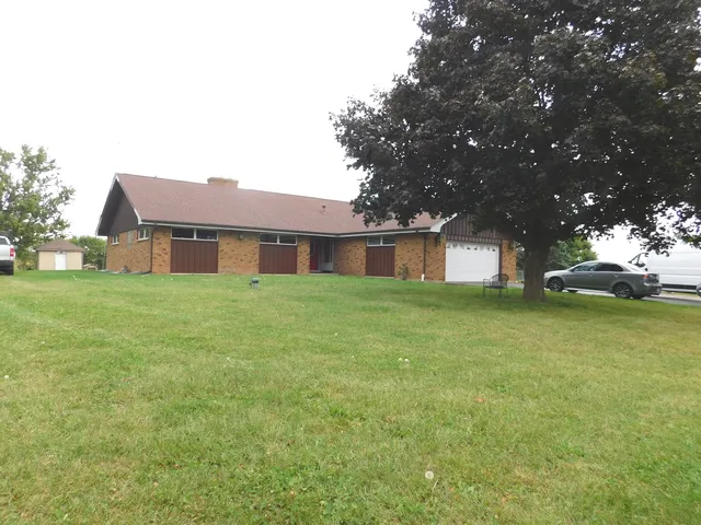 a front view of house with yard and trees