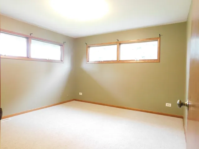 a bathroom with a sink a toilet a window and shower