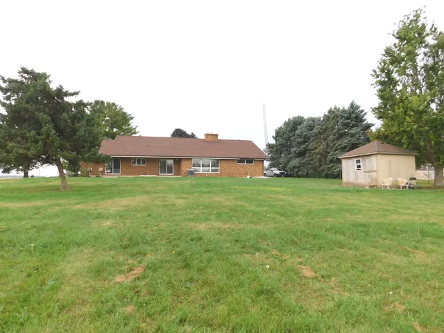 a front view of a house with a garden and yard