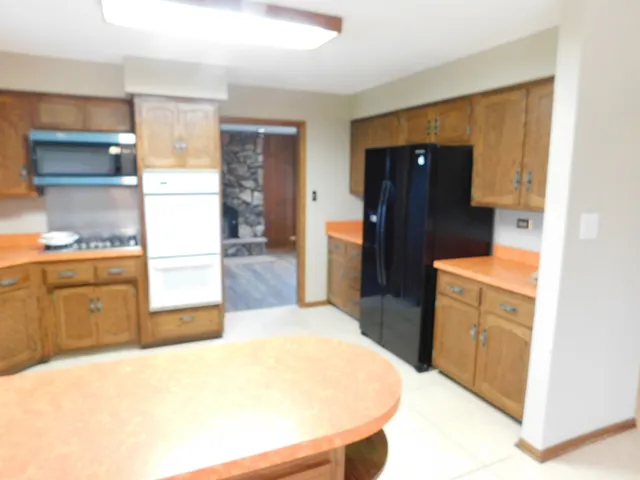 a kitchen with a refrigerator and cabinets