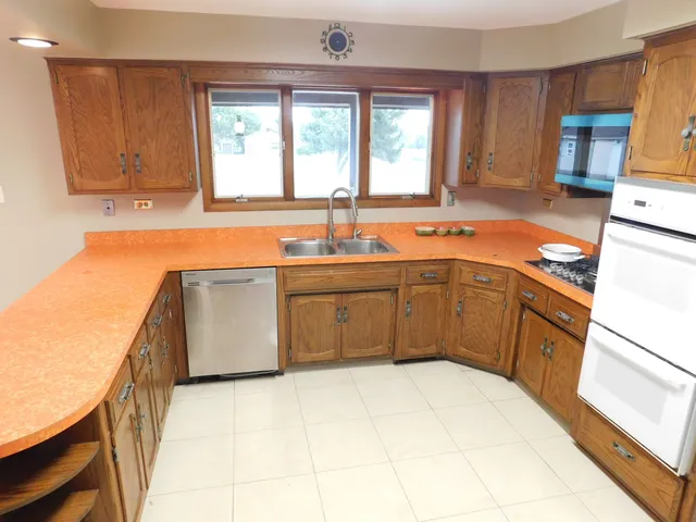 a kitchen with a sink stove and cabinets