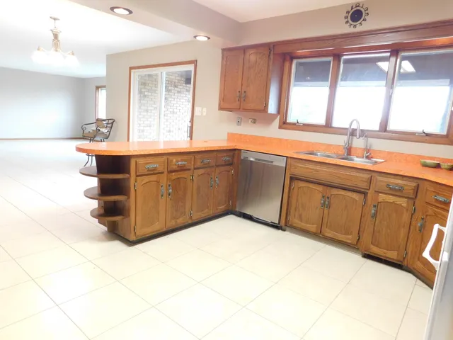 a kitchen with stainless steel appliances granite countertop a sink and cabinets