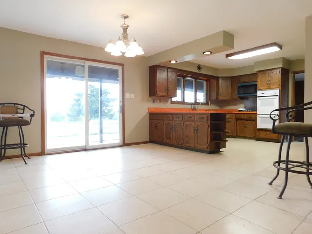 a living room with granite countertop furniture and a chandelier