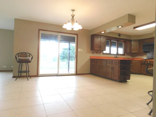 a large kitchen with stainless steel appliances granite countertop a sink and cabinets