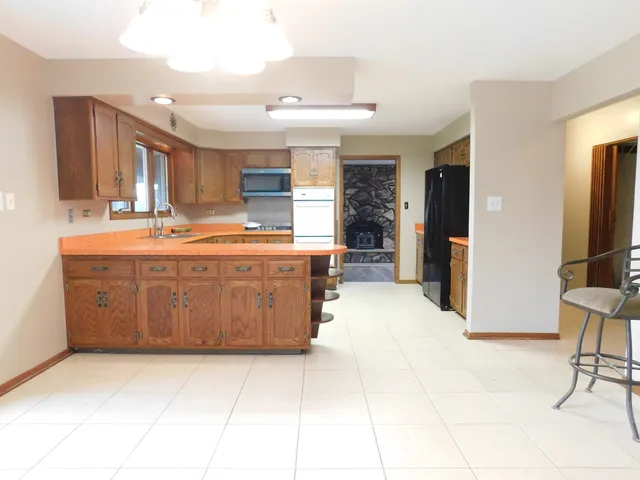 a large kitchen with kitchen island granite countertop a large counter top and appliances