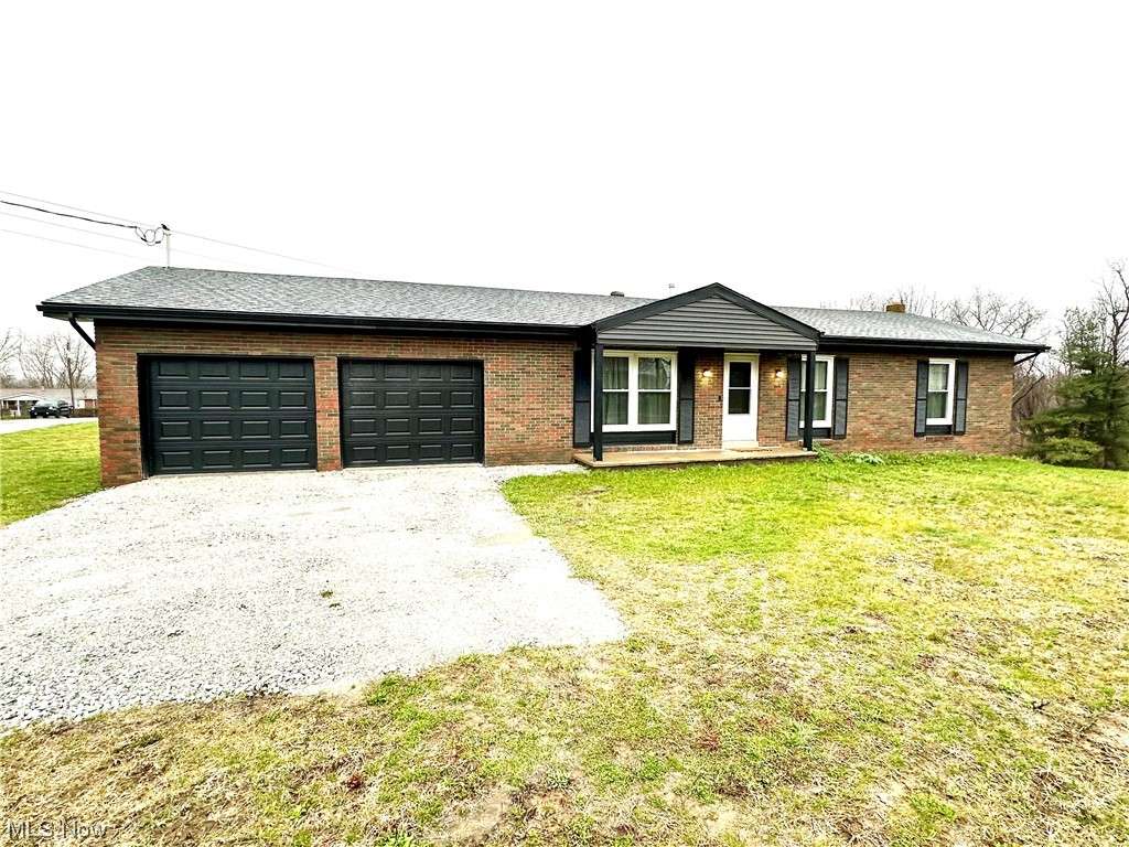 2039 St Johns Road Colliers, WV 26035 - Photo 1 of 35 Ranch-style home featuring a garage and a front yard
